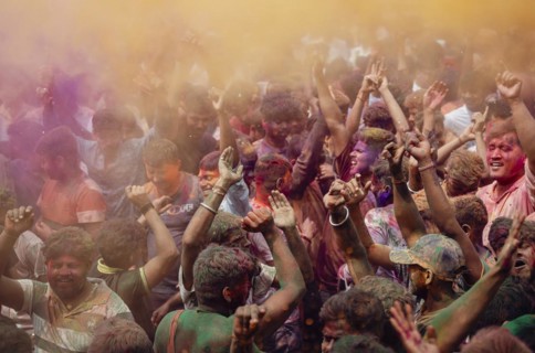 Revellers dancing in the beat of music as they celebrate Holi on a street, the Hindu spring