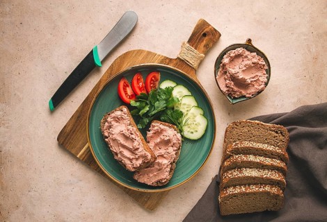 Liver meat pate spread on rye bread, breakfast, close-up, beige background. no people, selective