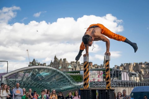 Street performers and spectators, acrobatic performance, Prince Street, world's largest cultural
