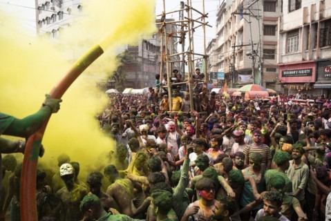 Revellers dancing in the beat of music as they celebrate Holi on a street, the Hindu spring