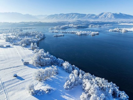 Aerial view of a lake in front of mountains, winter, snow, morning light, fog, Staffelsee, Alpine