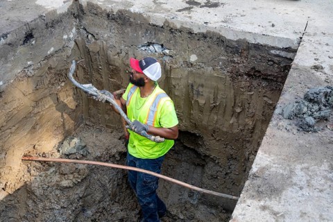 Detroit, Michigan, A workers holds a piece of an old lead water service line that is being replaced