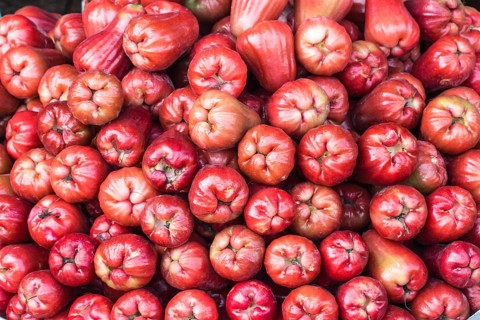 Stack of fresh rose apples on the market