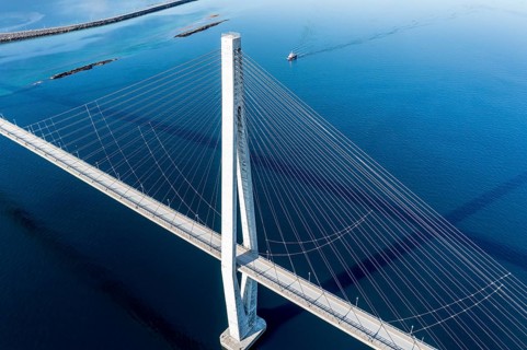 Aerial view of Helgeland bridge, connecting Sandnessjoen with the norwegian mainland, fishing boat