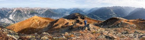 Panorama, mountaineer at the summit Kreuzjoch, view of summit Tschirgant and the Oberinntal and