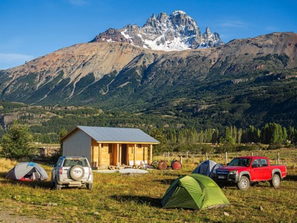Tents on campsite in village Villa Cerro Castillo, mountain Cerro Castillo in the back, Aysen