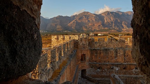 Evening light, battlements, courtyard, corner tower, mountains, Lefka Ori, White Mountains,