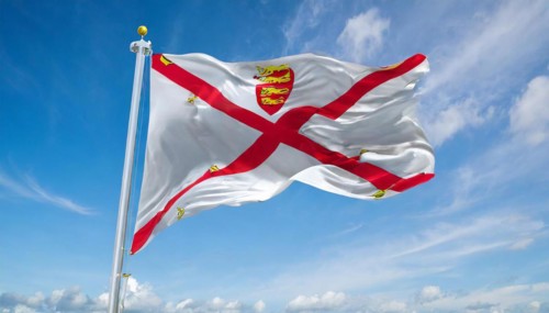 The flag of the Isle of Jersey, Great Britain flutters in the wind