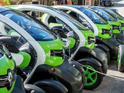 Electric powered Renault Twizy rental cars charging up at Geiranger, Norway, Europe