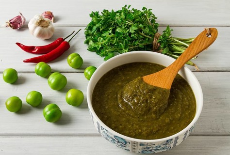 Tkemali sauce, traditional Georgian cuisine, green cherry plum, with ingredients for sauce,