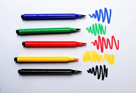Watercolor pens brush, assortment, on a drawing album, artist's desk, top view, close-up, selective