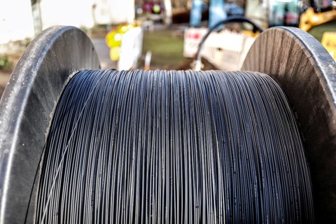Cable drum with fibre optic cable is lying on a construction site for laying, Berlin, 29.02.2024