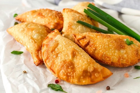 Fried chebureks, close-up, on a white background, no people