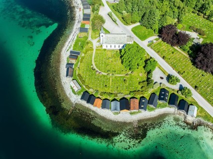 Aerial view of beach and church in Selje, wooden boat sheds, Stad, Vestland, Norway, Europe