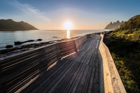 Coast at Tungeneset, sunset over the fjord, wooden path, view over rock formation to mountain range