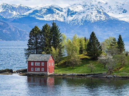 Typical red house on an island in the Hardangerfjord, near Strandebarm, Hordaland, Norway, Europe