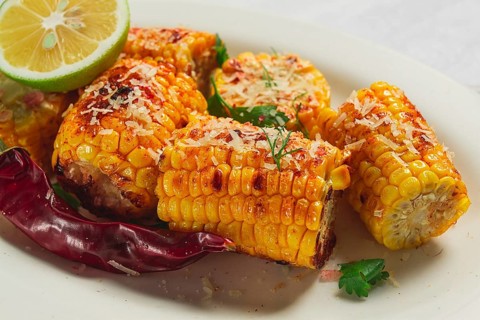 Grilled corn with spices, top view, no people, homemade
