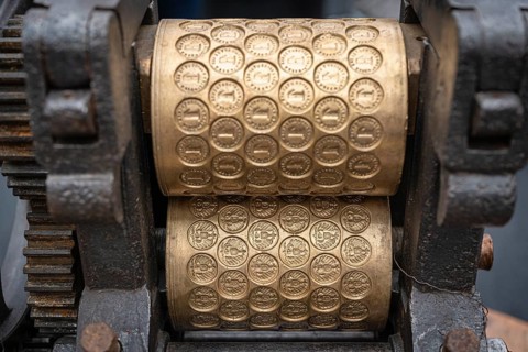 Old embossing machine with profiled metal rollers, machine parts, embossing rollers, brass matrices