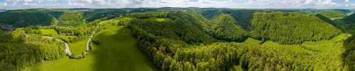 Winding country road through a forest, landscape of the Swabian Alb in spring, panoramic photo,