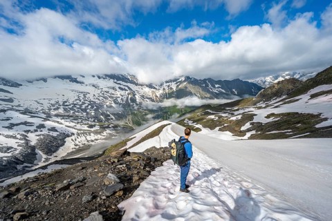 Mountaineer on hiking trail with snow, mountain landscape with summit Hoher WeiÃŸzint and