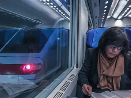 Woman Travel in a Train and Reading a Newspaper in Monte Carlo, Cote d azur, Monaco, Europe