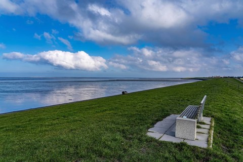 The Wadden Sea, East Frisia, between Bensersiel and Neuharlingersiel, Park bench on the dyke, Lower