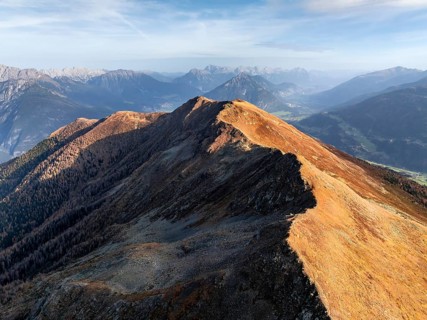 Venet mountain ridge at Kreuzjoch summit, view of Tschirgant summit and the Oberinntal valley, in