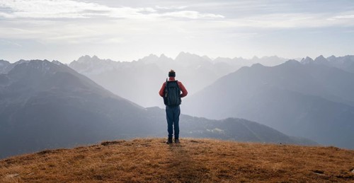 Mountaineers in front of a mountain panorama in the morning light, view from the Venet in autumn,