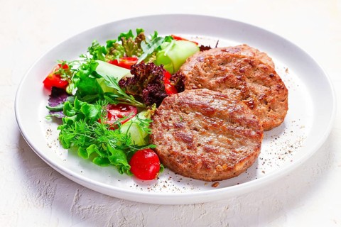 Fried cutlets, turkey, with vegetable salad, top view, no people