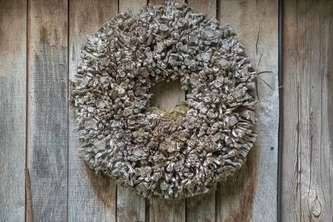 Door wreath made of natural materials in front of a wooden wall, Münsterland, North