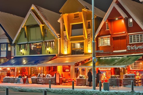 People sitting in front of a bar, winter, chrismas decoration, cold, gas powered heating stove