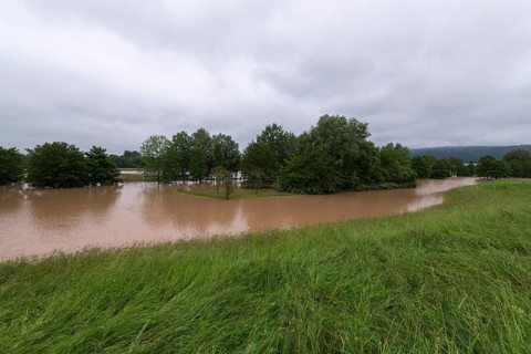Symbolic image extreme weather, global warming, climate change, flood retention basin, flood