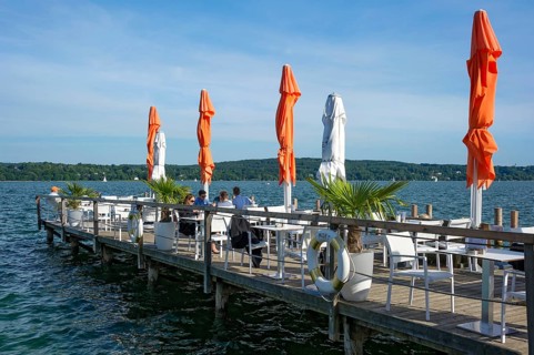 Old jetties with dining tables, lakeside restaurant, former Undosa wave pool, now H'ugo's Beach