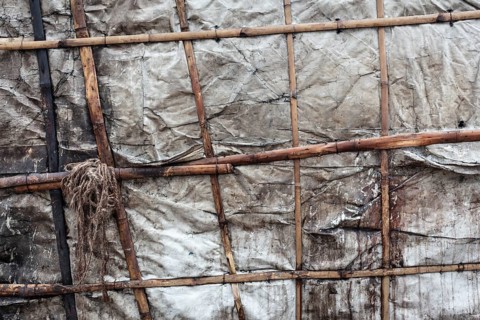 Detail of a makeshift dwelling made of plastic sheeting and bamboo sticks, Tejgaon Slum Area,