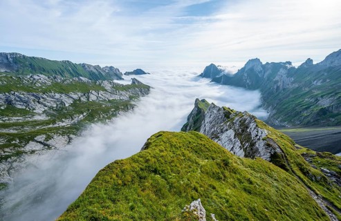 View of mountain peaks above the sea of clouds, SÃ¤ntis mountains and valley of Meglisalp, high