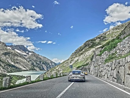 Photo with reduced saturation Porsche 911 GT3 on pass road of Grimselpass, Canton Uri, Switzerland,
