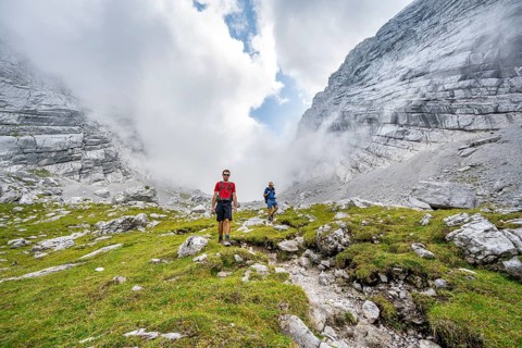 Two mountaineers on a hiking trail, cloudy mountain basin, descent via the Ofental valley, mountain