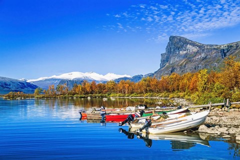 Motorboats at a jetty in a mountain lake at Sarek National Park in Lapland in the north of Sweden,