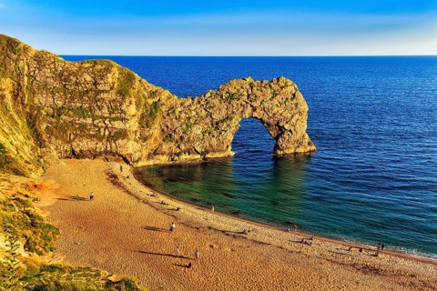 Coastline with bathing beach at Durdle Door, limestone rock bridge, UNESCO World Heritage Site,