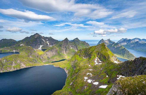 Mountain landscape with steep rocky peaks fjords and sea, view from the top of Munken to lakes