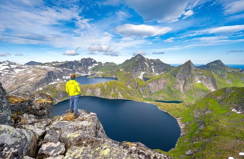 Mountaineers at the summit of Munken, mountain landscape with steep rocky peaks, lakes Tennesvatnet