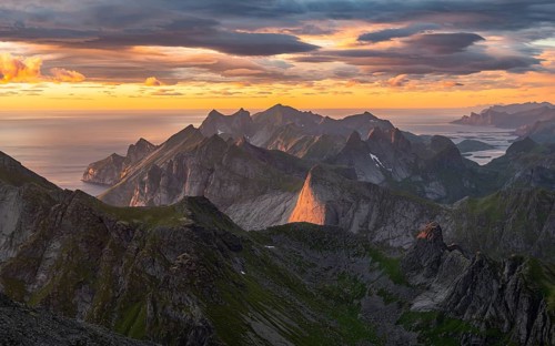 View over mountain top and sea, dramatic sunset, from the top of Hermannsdalstinden, Moskenesöy,