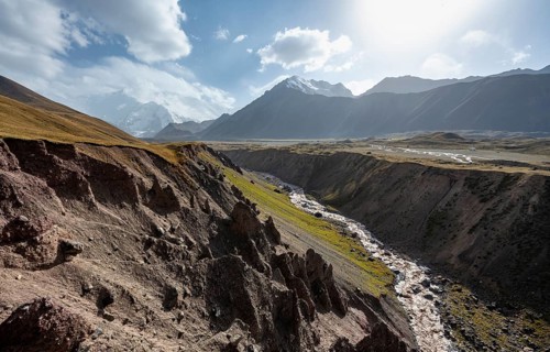 Valley with river Achik Tash between high mountains, mountain landscape with peak Pik Lenin, Osh