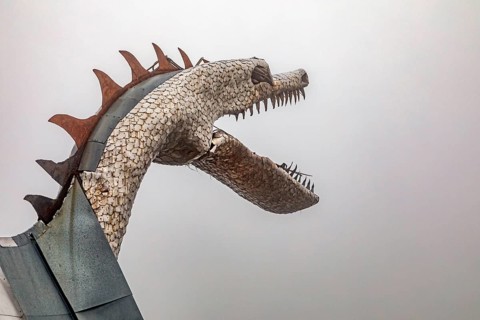 Rye, Colorado, The dragon on Bishop Castle on a foggy morning. The Castle is an elaborate stone and
