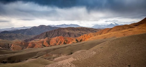 View over eroded mountainous landscape of Konorchek Canyon with red sandstone cliffs, high