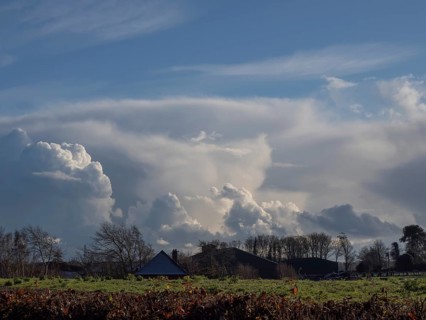 Dramatic clouds over Sussex on a Winter's late afternoon, with farm buildings and trees in