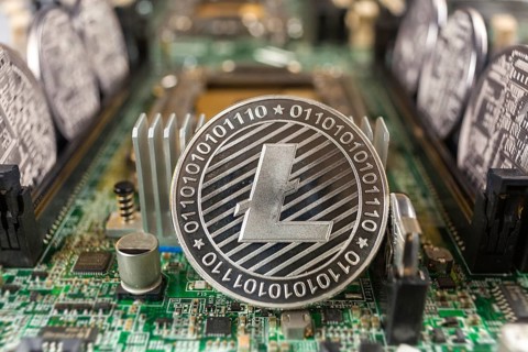 Litecoin close-up on a computer circuit motherboard as a blockchain technology payment network.