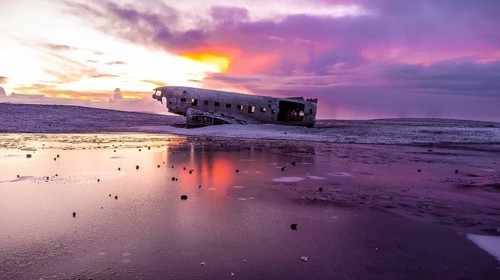Aerial drone view at sunrise on crashed plane on frozen Solheimasandur beach in winter, Iceland,
