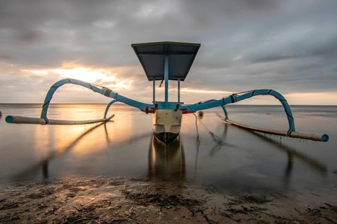 Jukung in the sea, typical landscape shot with a view of the horizon over the water, taken from a