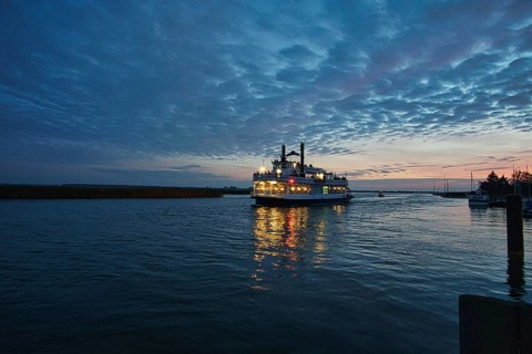 From the harbor in zingst the bodden view with burning sky with steamer, dynamic clouds in full